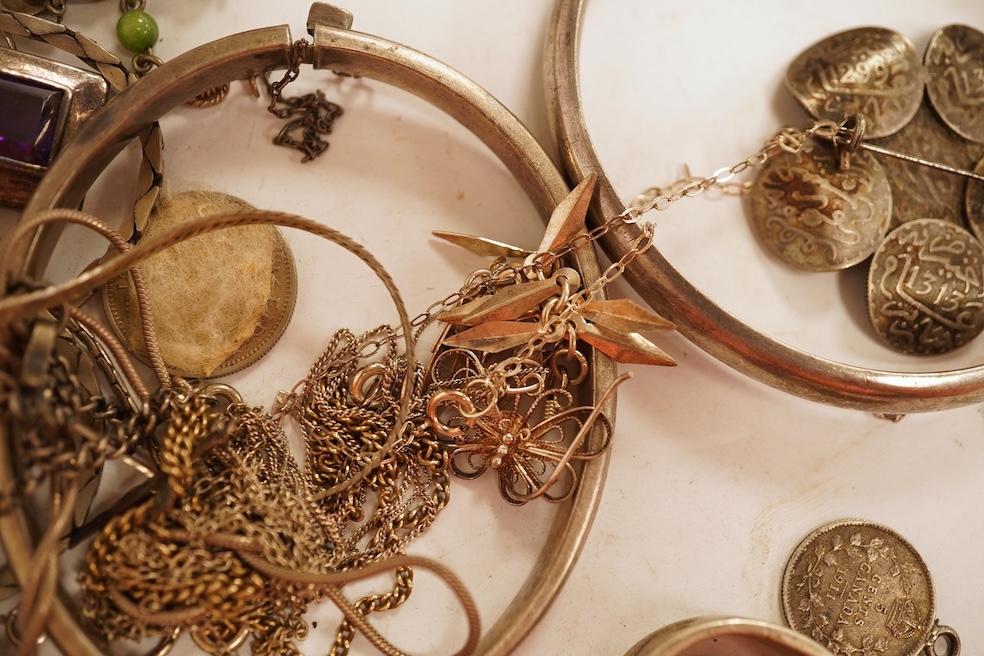 A small group of silver and white metal jewellery including Siamese enamelled bangle, silver chain, drop earrings, Persian coin brooch, etc.